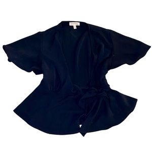 Navy blue blouse with ribbon around waist.